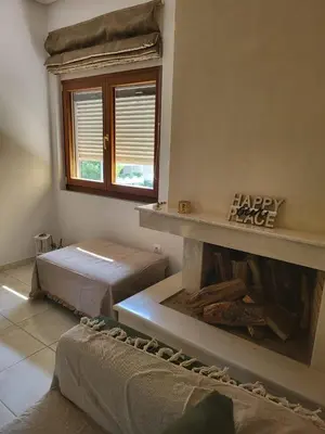 a living room with a happyride sign above a fireplace at Luxe Apartment in Central Glyfada in Athens