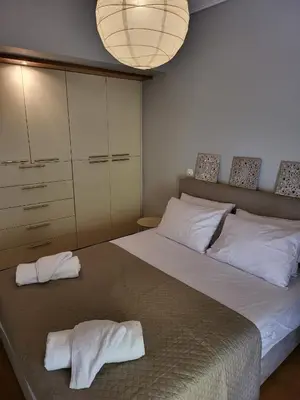 a bedroom with a large bed with towels on it at Luxe Apartment in Central Glyfada in Athens