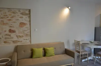 a living room with a couch and a table at Harihara Guesthouse near Airport in Paianía