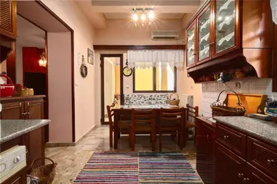 a kitchen with a table and a dining room at Spacious central apartment wh free parking spaces in Athens
