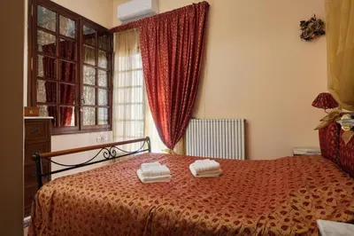 a bedroom with a bed with two towels on it at Spacious central apartment wh free parking spaces in Athens