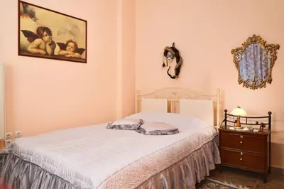 a bedroom with a bed and a painting on the wall at Spacious central apartment wh free parking spaces in Athens