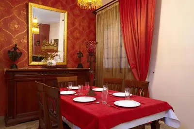 a dining room with a table with a red table cloth at Spacious central apartment wh free parking spaces in Athens