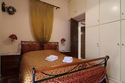 a bedroom with a bed with two towels on it at Spacious central apartment wh free parking spaces in Athens
