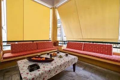 a room with two red couches and a table with food on it at Spacious central apartment wh free parking spaces in Athens