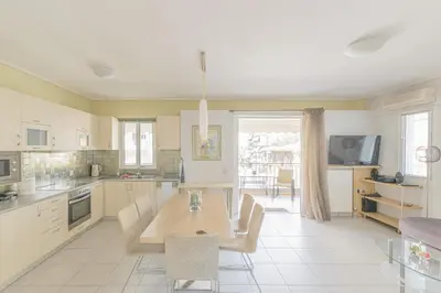 a kitchen with a table and chairs in it at Family Sunny 2 bedroom near center 50m busstop,300m busstop Acropolis in Athens