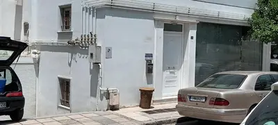 a white house with a car parked in front of it at Family Sunny 2 bedroom near center 50m busstop,300m busstop Acropolis in Athens