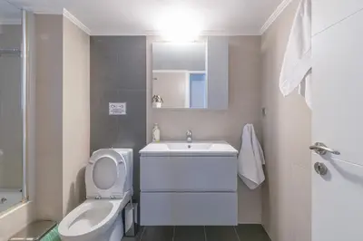 a white bathroom with a toilet and a sink at Family Sunny 2 bedroom near center 50m busstop,300m busstop Acropolis in Athens