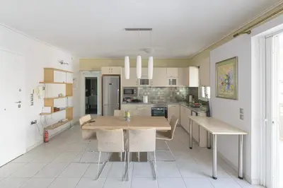 a kitchen with a table and chairs in a room at Family Sunny 2 bedroom near center 50m busstop,300m busstop Acropolis in Athens