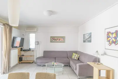 a living room with a couch and a table at Family Sunny 2 bedroom near center 50m busstop,300m busstop Acropolis in Athens