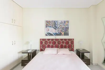 a bedroom with a large bed with two night stands at Family Sunny 2 bedroom near center 50m busstop,300m busstop Acropolis in Athens