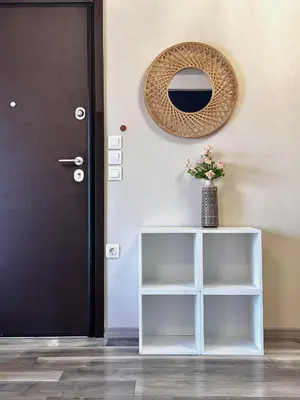 a black door and a vase with flowers on a shelf at Dafni City Apartment 5 in Athens
