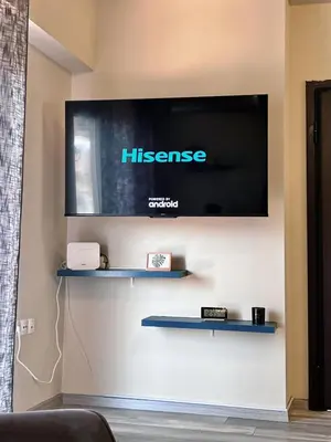 a flat screen tv hanging on a wall at Dafni City Apartment 5 in Athens