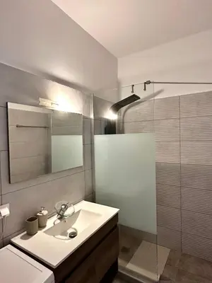 a white bathroom with a sink and a shower at Dafni City Apartment 5 in Athens