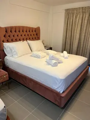 a large bed in a bedroom with towels on it at Airport Luxury Stay in Artemida