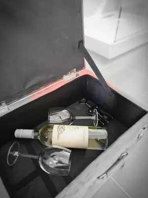 a bottle of wine and two glasses in a box at Airport Luxury Stay in Artemida