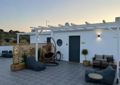 a patio with a couch and a pergola at Airport Luxury Stay in Artemida