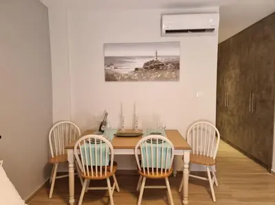 a dining room with a wooden table and chairs at Harmony in everything in Athens