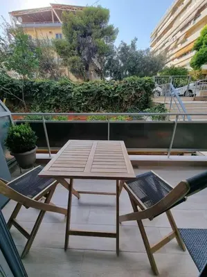 a wooden table and two chairs on a balcony at Harmony in everything in Athens