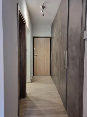 an empty hallway with a wooden door and a hallwayngthngthngthngth at Harmony in everything in Athens