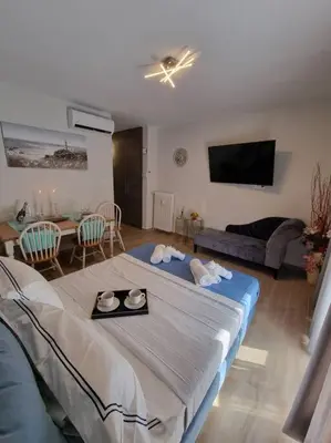 a bedroom with a bed and a living room with a table at Harmony in everything in Athens
