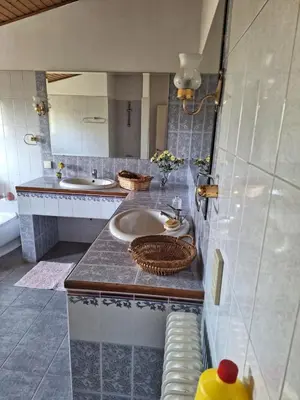 a bathroom with two sinks and a mirror at Metro Paĺlini Rooms to Rent 20 min to Syntagma 15 minutes to Airport 24 hours train Bus and 200 meter aŵay in Pallíni