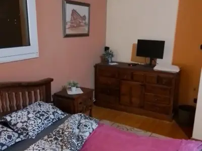 a bedroom with a bed and a television on a dresser at Metro Paĺlini Rooms to Rent 20 min to Syntagma 15 minutes to Airport 24 hours train Bus and 200 meter aŵay in Pallíni