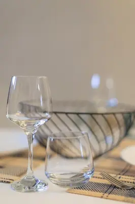 two wine glasses sitting on top of a table at Aiolos new Smyrni view loft suite in Athens