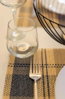 a fork sitting next to a glass on a table at Aiolos new Smyrni view loft suite in Athens