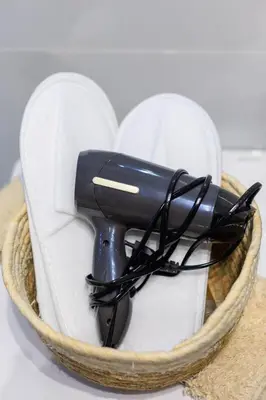 a hair dryer sitting on a pair of white shoes at Aiolos new Smyrni view loft suite in Athens