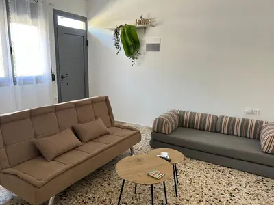 a living room with a couch and a table at Paola’s Apartment Near Athens Airport in Spáta