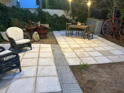 a patio with two chairs and a table and a table and chairs at Paola’s Apartment Near Athens Airport in Spáta