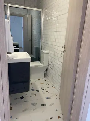 a bathroom with a sink and a toilet at Paola’s Apartment Near Athens Airport in Spáta