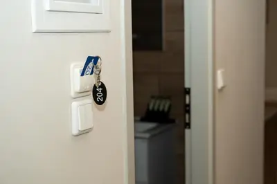 a door lock with a key in a bathroom at Anesis Airport rooms 204 in Koropíon