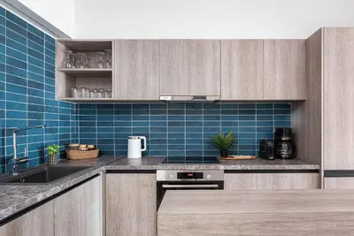 a kitchen with a sink and blue tiles at Glyfada Unique Residence in Athens
