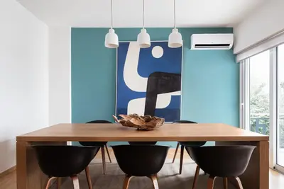 a dining room with a wooden table and chairs at Glyfada Unique Residence in Athens