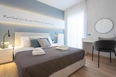 a bedroom with a bed with two towels on it at Luxury 4 Bedrooms Apartment Near Flisvos Marina in Piraeus