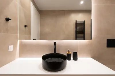 a bathroom with a black sink and a mirror at Luxury 4 Bedrooms Apartment Near Flisvos Marina in Piraeus