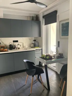 a kitchen with a table and some chairs and a counter at Only2Suites in Athens