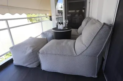 two chairs sitting in a room with a window at Only2Suites in Athens