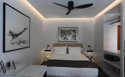 a bedroom with a bed and a ceiling fan at Only2Suites in Athens