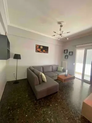 a living room with a couch and a table at Lovely flat Korydallos in Piraeus