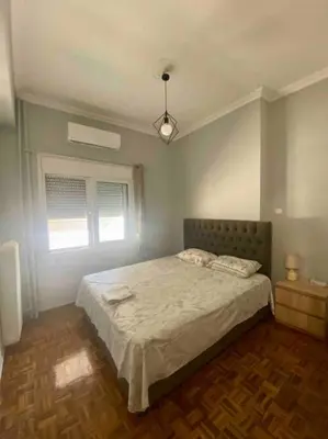 a bedroom with a bed and a window at Lovely flat Korydallos in Piraeus