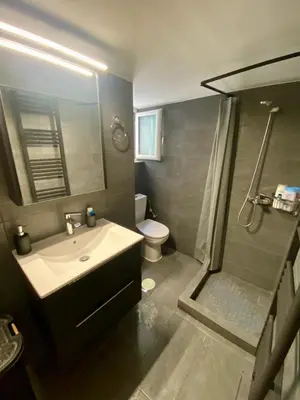 a bathroom with a sink and a shower and a toilet at Cozy flat Korydallos in Piraeus