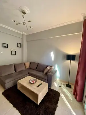 a living room with a couch and a coffee table at Cozy flat Korydallos in Piraeus