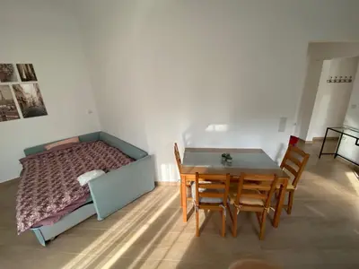 a bedroom with a bed and a table and chairs at Azure House in Athens