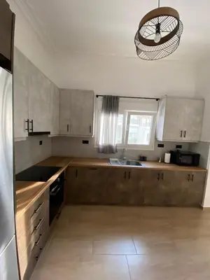 a kitchen with wooden cabinets and a sink and a chandelier at Azure House in Athens
