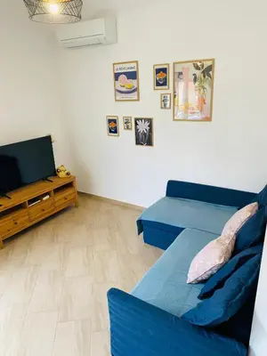 a bedroom with a blue bed and a couch at Azure House in Athens