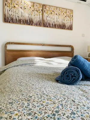 a bed with a blue pillow on top of it at Azure House in Athens