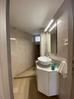 a bathroom with a white sink and a mirror at Azure House in Athens